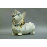 A pottery money box modelled as a corgi wearing a crown