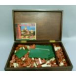 A mahogany box of mini bricks, the complete building system in miniature with all rubber bricks,