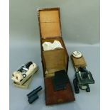 An early 20th century students microscope in mahogany carrying case, together with a glass slide