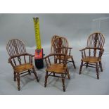 A set of four reproduction miniature broad arm Windsor elbow chairs of conventional design with