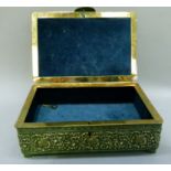 A gilt metal jewel casket rectangular with semi domed cover, the case all over worked with