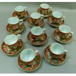 A set of ten Japanese pottery cups and saucers painted with garden landscapes within reserves on