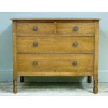 An oak chest of two short and two long drawers, later handles and on turned feet