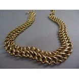 A necklace by Monet of graduated double curb links in gilt