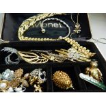 A small collection of costume jewellery including brooches by Monet within a Monet box