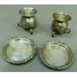 A pair of Mexican sterling silver globular candlestands with circular stands, approximate weight