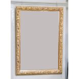 A gilt leaf moulded wall mirror rectangular with bevelled glass, 103cm x 73cm