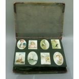 A Victorian scrap album oval and rectangular cards, various subject matters including cats,