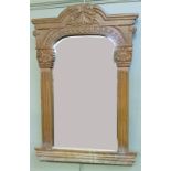 A wall mirror with architectural frame