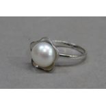A dress ring set to the centre with a 10mm freshwater cultured pearl, in silver