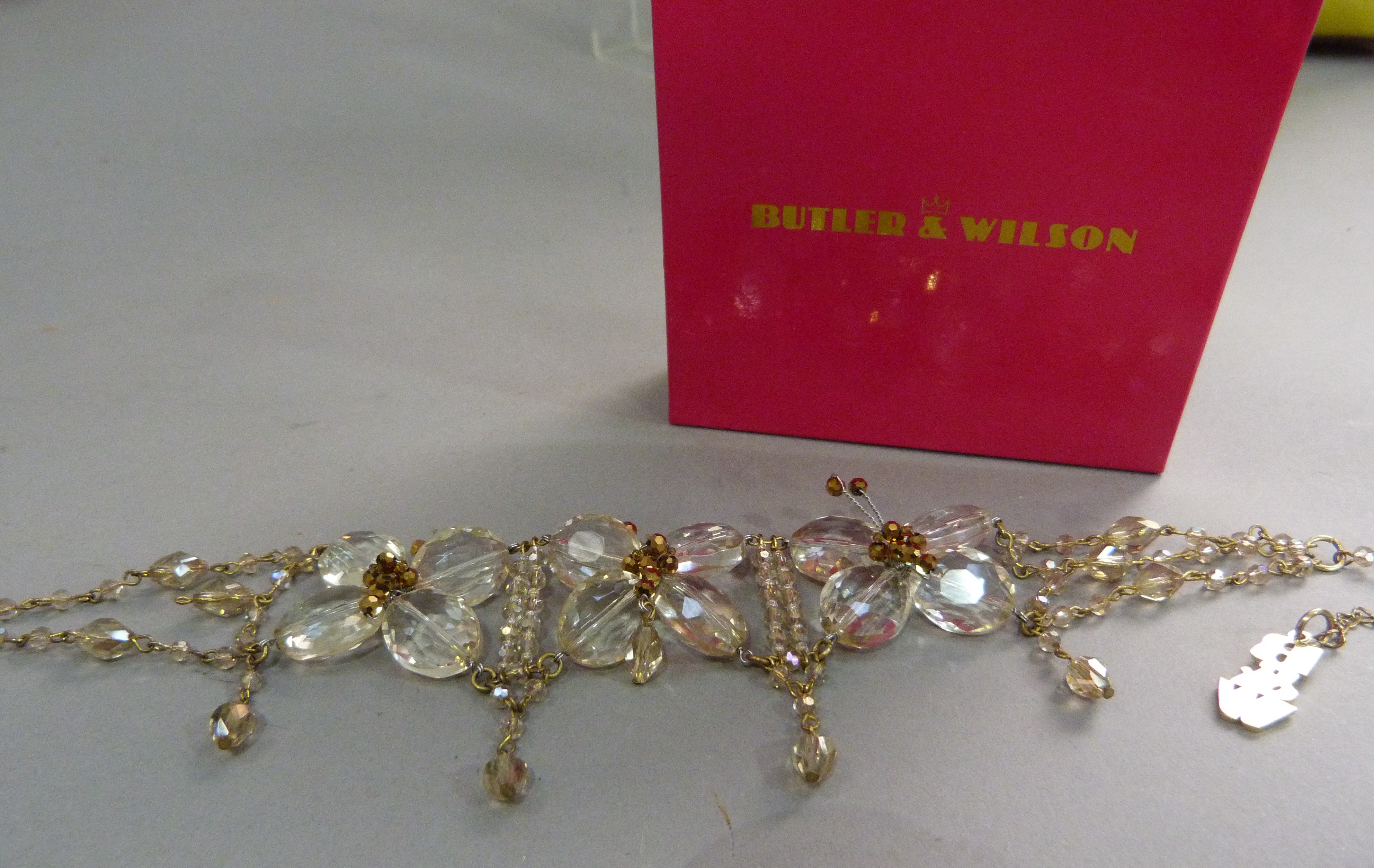A necklace by Butler & Wilson set to the front with three butterfly clusters of large oval faceted