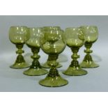 A set of six green glass rummers on domed foot