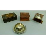 A white metal cup and saucer, purchased in Bangalore 1935; together with a carved hardwood box,