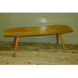 A 1960s/70s oak coffee table on splayed legs, 129cm x 39cm