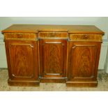 A Victorian mahogany sideboard of inverted breakfront having three drawers across inlaid with
