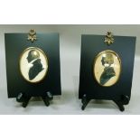A pair of silhouettes of gentleman oval, in ebonised frames with acorn hanging loops