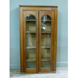 A Victorian middle section from a larger book case having two arch glazed doors, the interior fitted