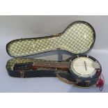 An eight string banjo with ebonised circular belly and mahogany stained neck, the finger board