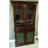 A Victorian mahogany cabinet having a moulded cornice above two arched glass doors and two