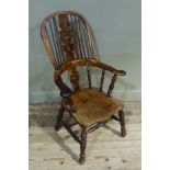 A 19th century yew wood high back broad arm elbow chair with pierced 'Christmas tree' splat,