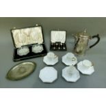 A cased set of two cut glass butter dishes, a cased set of silver plated coffee spoons with