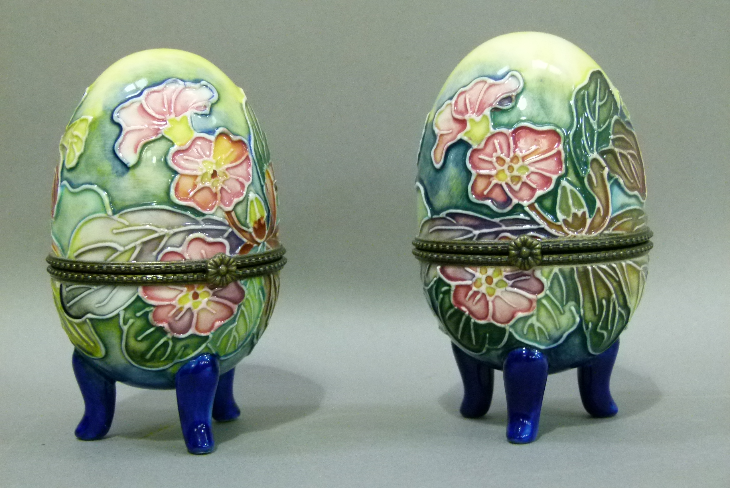 A pair of Old Tupton ware egg shaped trinket boxes each tube lined and painted with trailing flowers