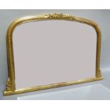 A modern gilt over mantel mirror with beaded frame and foliate cresting and bevelled plate, width