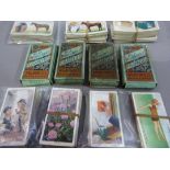 A small quantity of cigarette cards to include: WD & HO Wills - Wild Flowers, Ogdens- How to Swim,