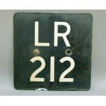 A black and white enamel rounded square plate intialled and numbered LR212, 31cm wide