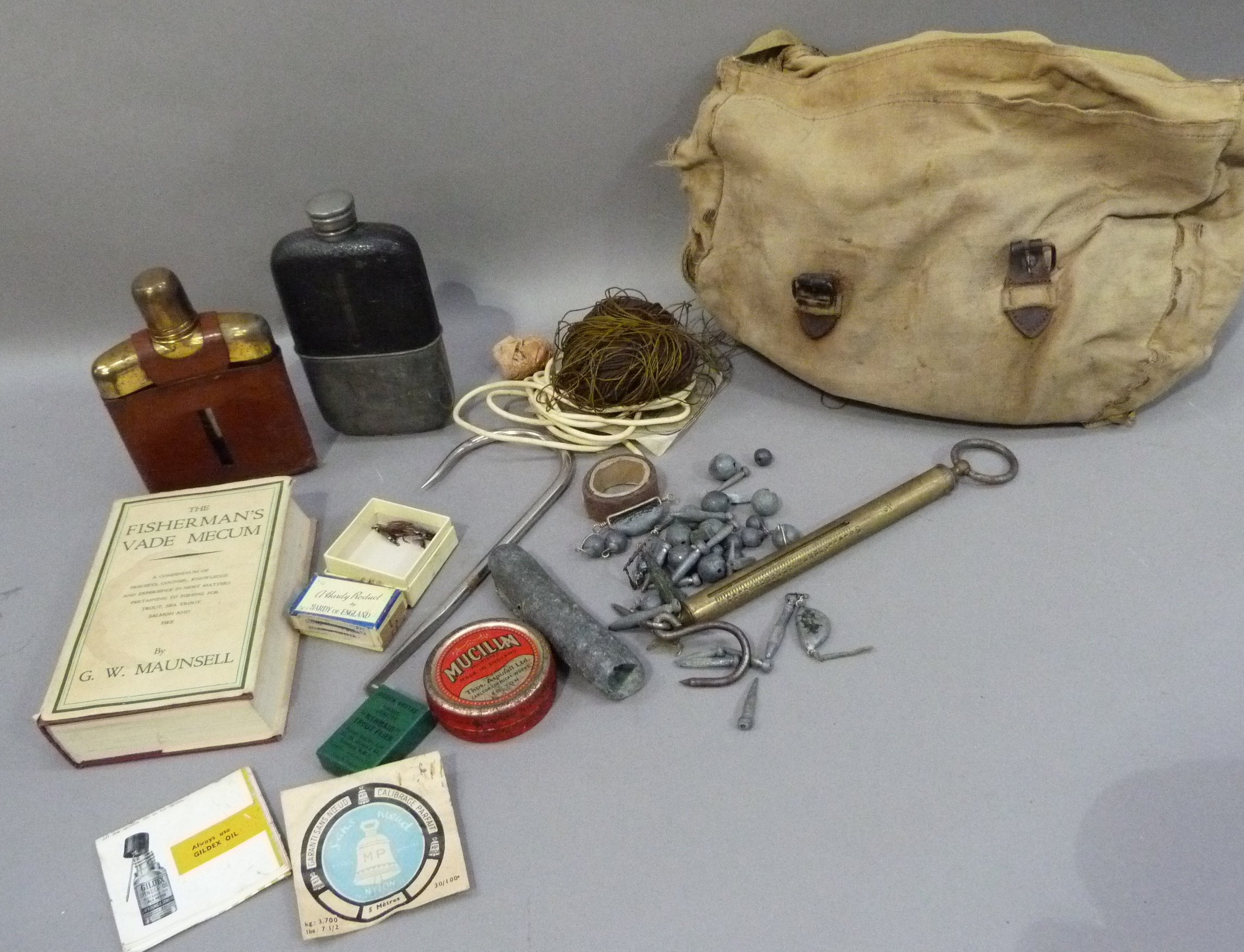 A canvas bag containing a small quantity of fisherman's equipment and other items including lead