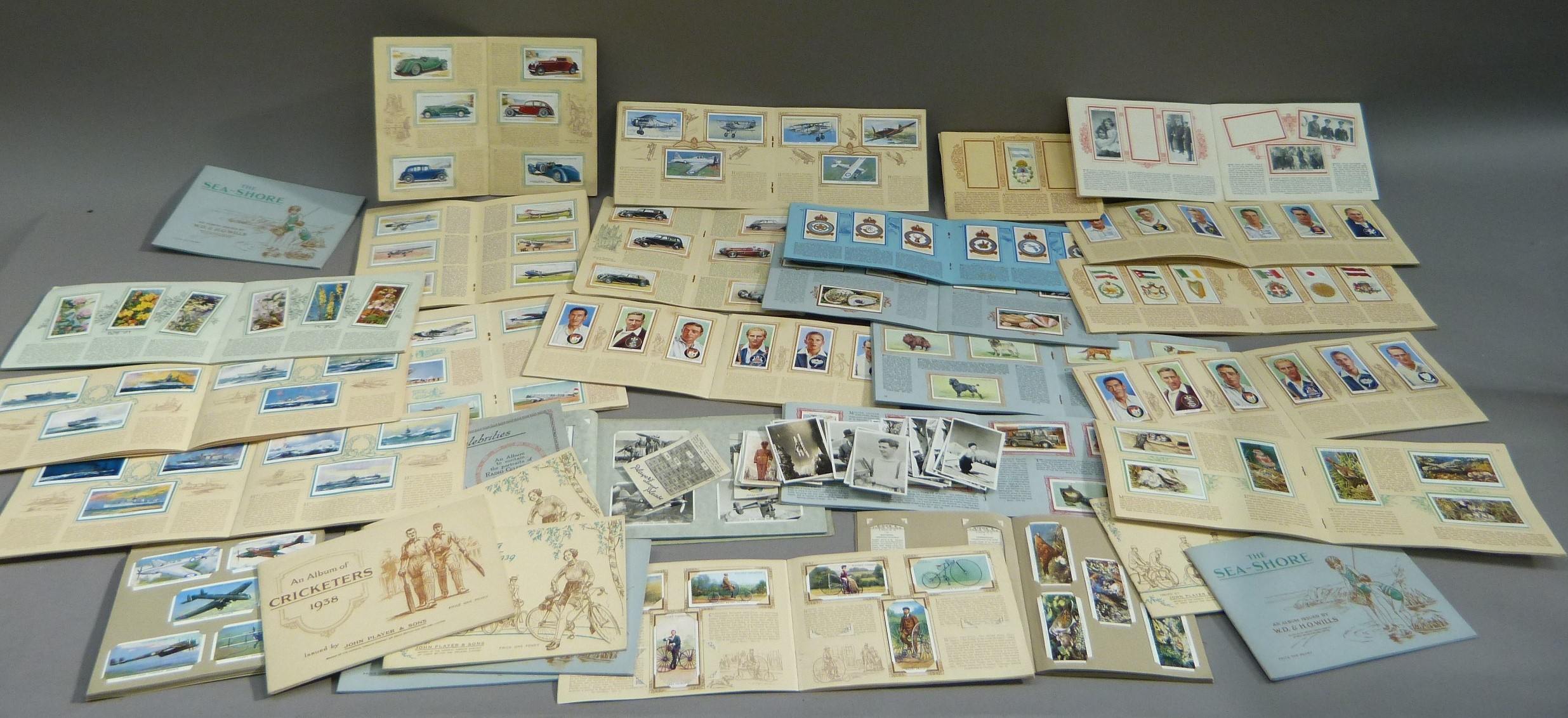 A quantity of cigarette cards all contained in paper albums including: John Players Motor cars