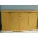 A modern sideboard with two drawers above two cupboard doors flanked by a cupboard to either side,