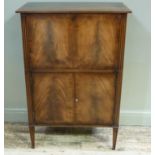 A mahogany cocktail cabinet having a lift up and drop front compartment lined with mirror above