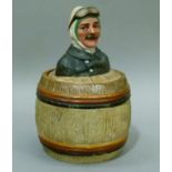 A 19th century Austrian pottery tobacco jar and cover modelled as head and shoulders of a pilot