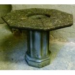 A garden octagonal table with dished centre raised on a panelled octagonal pillar, concrete 76cm