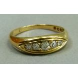 An Edward VII five stone diamond ring in 18ct gold, the graduated old cut stones grain set in line