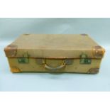 A canvas and leather bound vintage suitcase initialled EH, with key