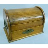 An Edwardian oak tambour top desk or smoker's compendium with compartments, pair of carrying handles