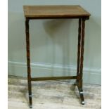 An early 20th century rosewood occasional table on twin turned refectory standards from a nest of