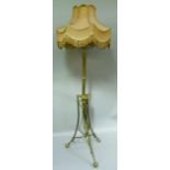 A late Victorian brass standard lamp the column with a triangular collar and on three downswept legs