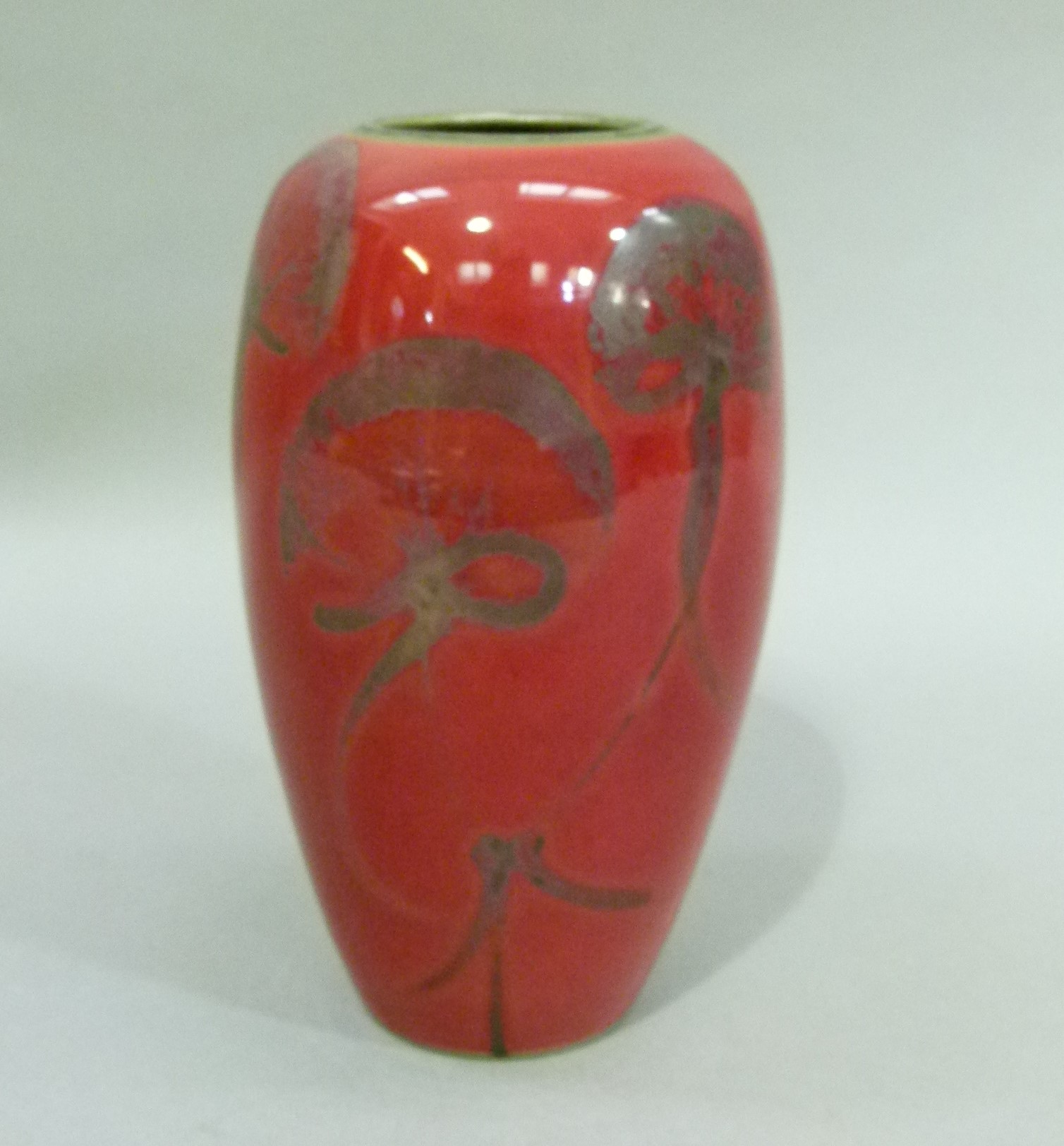 A red flambe vase of ovoid form, decorated with flowers, 20cm high