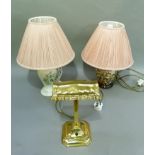 Two pottery table lamps and a lacquered brass student type lamp together with a pair of pink pleated