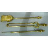 A set of Victorian brass fire irons with baluster handles comprising a pair of tongs, poker and