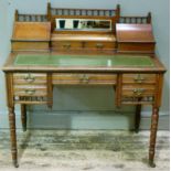 A Victorian desk having a raised back with mirror and two serpentine lidded boxes, green leather