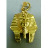 An Egyptian pendant, the Pharaoh's mask in yellow metal (tests as 18ct gold) with Egyptian