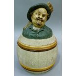 A 19th century Austrian tobacco jar and cover modelled as a jovial gentleman wearing a hat sitting