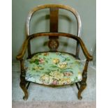 An oak chair with arched back and scrolling arms serpentine stuffed over seat on cabriole legs and