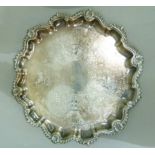 A silver plated salver of pie crust rim, cast with gadroon and engraved to the centre with shells,