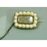 A Victorian pearl set mourning brooch on 9ct gold, the plaited hair set to the centre within a