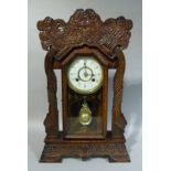 A New Haven Clock Co 8 day Norwich Line striking wall clock in a carved pine case, 63cm high